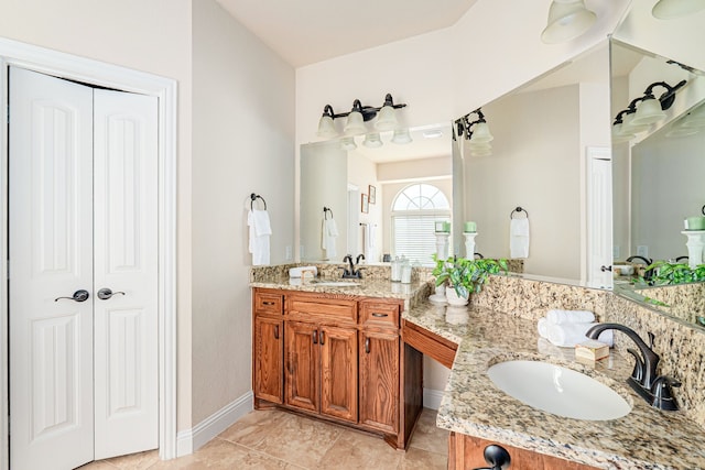 bathroom featuring a closet, baseboards, vanity, and tile patterned flooring