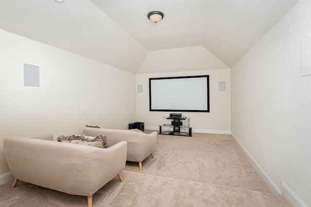 home theater with baseboards, carpet, and vaulted ceiling