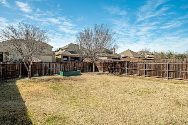 view of yard with a fenced backyard