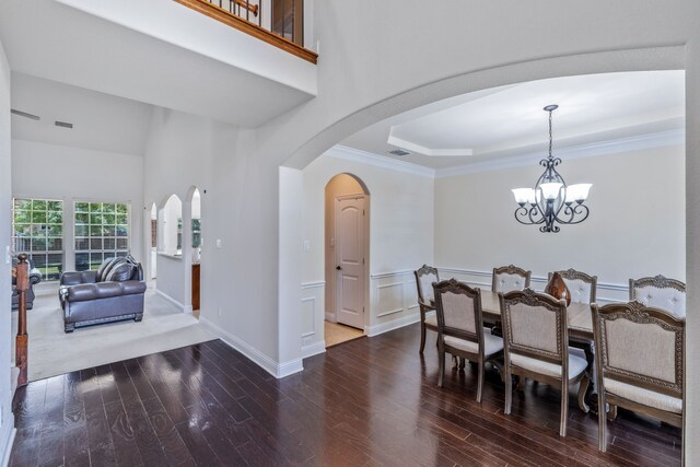 3506 Edinburgh Dr, Sachse, TX 75048 - dining room with wood finished floors, a chandelier, arched walkways, a tray ceiling, and baseboards