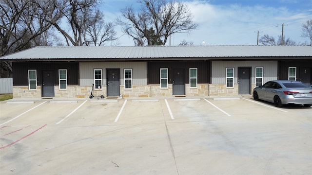 view of property featuring uncovered parking