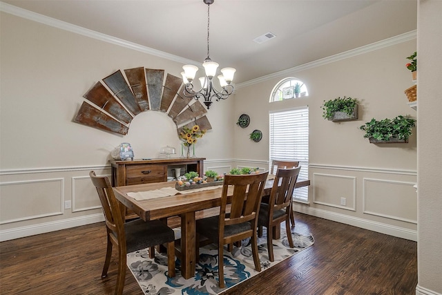 dining area with dark wood finished floors, visible vents, wainscoting, and a notable chandelier