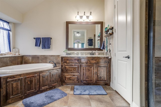 full bath with vanity, a bath, and ceiling fan