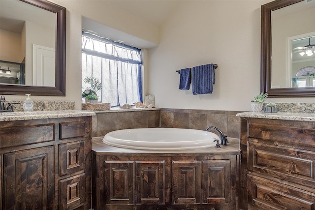 full bathroom featuring a sink, a garden tub, and two vanities