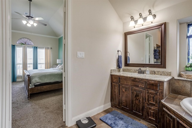 ensuite bathroom with visible vents, ceiling fan, baseboards, lofted ceiling, and vanity