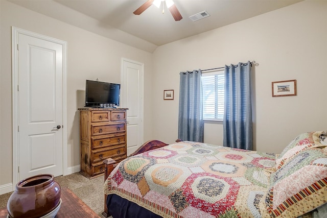 carpeted bedroom with a ceiling fan, visible vents, and baseboards