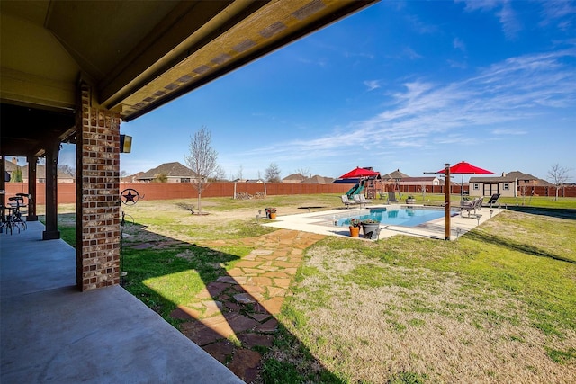 view of yard featuring a fenced backyard, a fenced in pool, and a patio