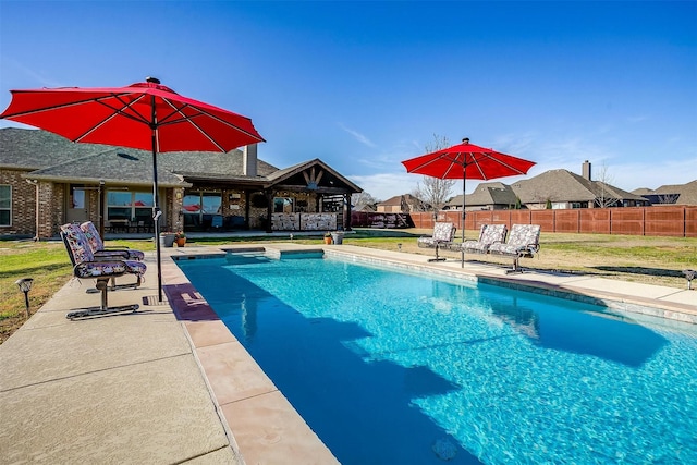 view of pool with a fenced in pool, a patio, a yard, and fence