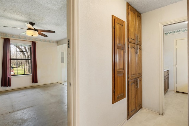 corridor featuring a textured ceiling