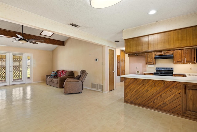 kitchen featuring light countertops, visible vents, black electric range oven, and under cabinet range hood