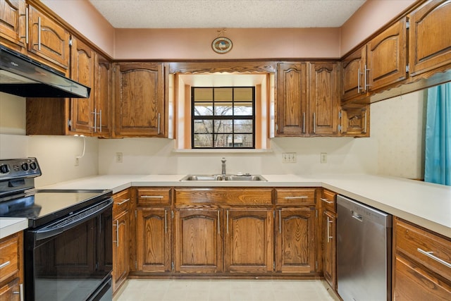 kitchen featuring electric range, a sink, under cabinet range hood, stainless steel dishwasher, and brown cabinetry