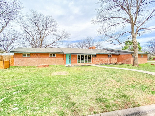 ranch-style home featuring a front lawn, fence, brick siding, and a chimney