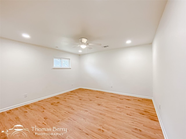 spare room with visible vents, light wood-style flooring, baseboards, and a ceiling fan