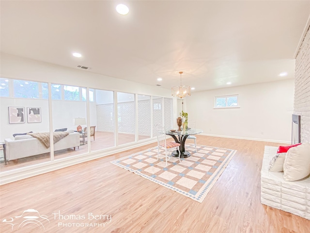 sitting room featuring baseboards, visible vents, an inviting chandelier, recessed lighting, and light wood-type flooring