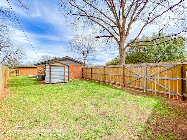 view of yard with a storage unit, an outdoor structure, and a fenced backyard