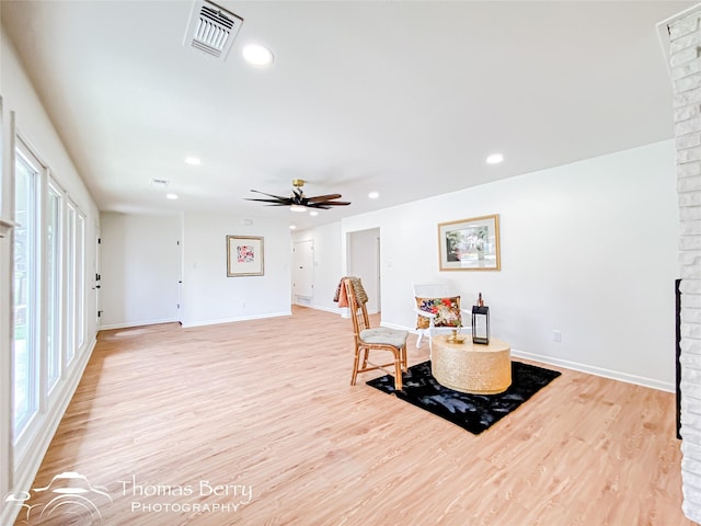 sitting room with light wood-style flooring, recessed lighting, visible vents, and baseboards