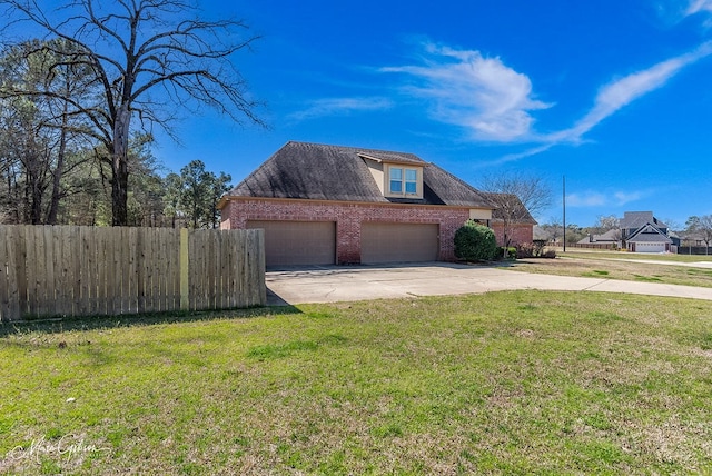 view of side of home featuring a yard, brick siding, driveway, and fence