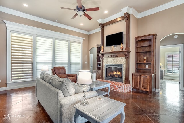 living room with baseboards, recessed lighting, a fireplace, ceiling fan, and crown molding