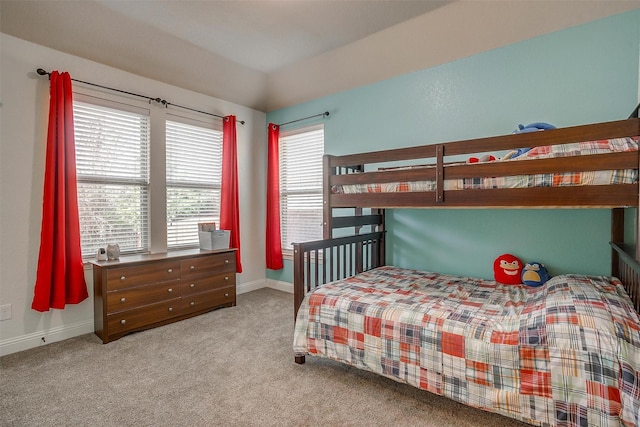 carpeted bedroom featuring baseboards