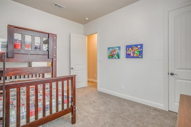 carpeted bedroom featuring visible vents and baseboards