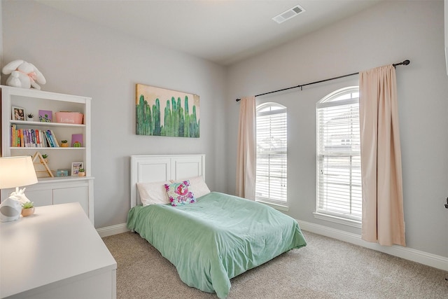 bedroom featuring visible vents, multiple windows, and light colored carpet