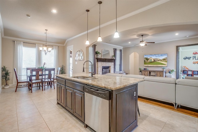 kitchen featuring crown molding, light stone countertops, a fireplace, stainless steel dishwasher, and a sink