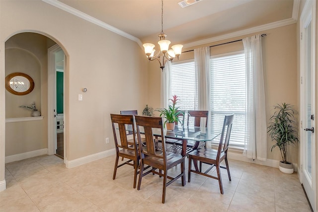 dining space with a wealth of natural light, a notable chandelier, arched walkways, and ornamental molding