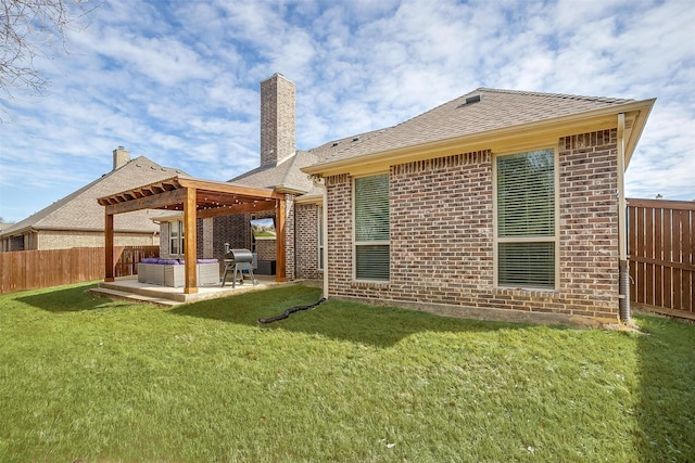 rear view of property featuring a yard, a fenced backyard, a pergola, a patio area, and brick siding