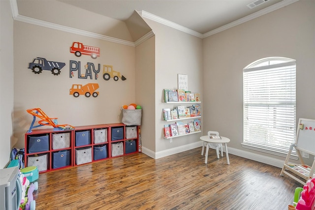 game room featuring visible vents, baseboards, wood finished floors, and ornamental molding