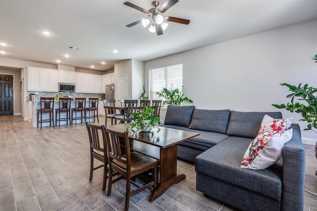 living area with visible vents, recessed lighting, light wood-style floors, and ceiling fan