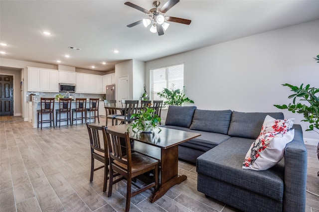 living room featuring recessed lighting, a ceiling fan, light wood-type flooring, and visible vents