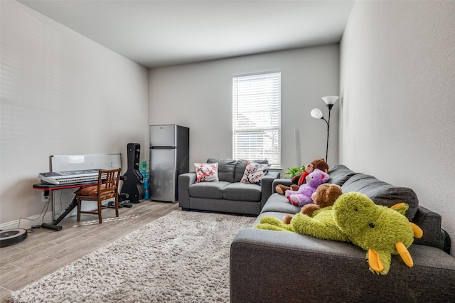 living area featuring wood finished floors and baseboards