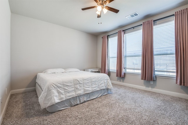 carpeted bedroom with baseboards, ceiling fan, and visible vents