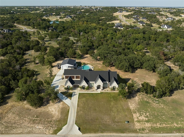 birds eye view of property with a forest view