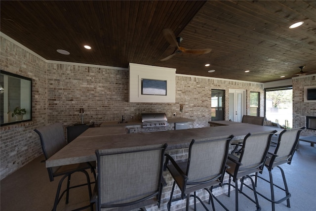dining area with recessed lighting, brick wall, wood ceiling, ceiling fan, and an outdoor brick fireplace