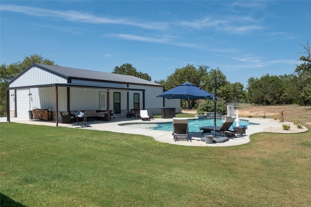 pool with a patio area, an outdoor hangout area, an outbuilding, and a yard