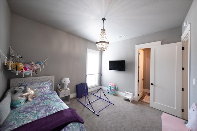 carpeted bedroom with visible vents, baseboards, and a chandelier
