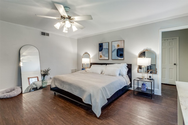 bedroom with visible vents, crown molding, ceiling fan, baseboards, and wood finished floors