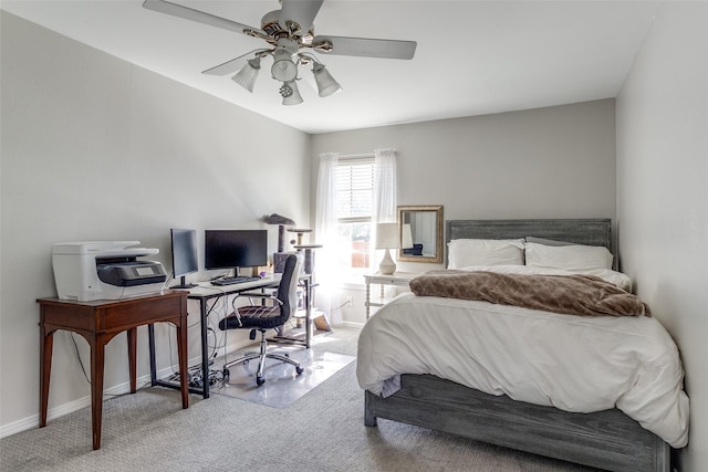 carpeted bedroom featuring baseboards and a ceiling fan