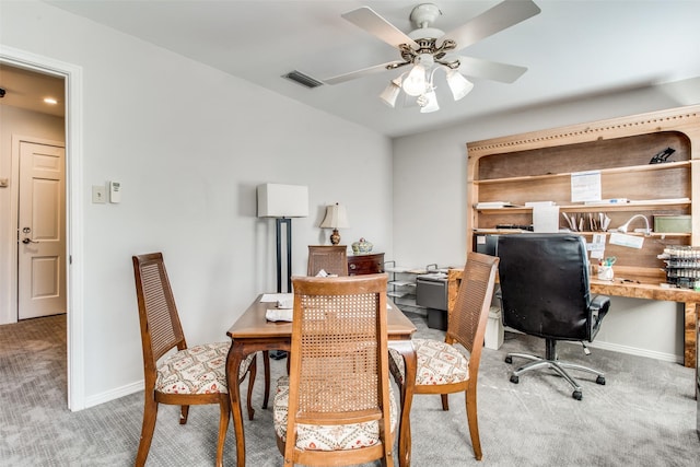 carpeted office with visible vents, ceiling fan, and baseboards