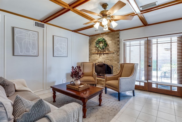 living area featuring a ceiling fan, visible vents, coffered ceiling, beamed ceiling, and a decorative wall