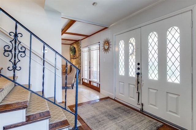 tiled entrance foyer with stairway and crown molding