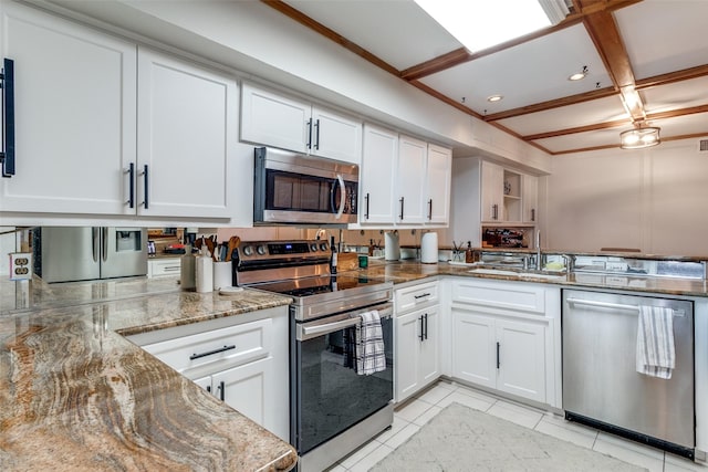 kitchen featuring a sink, stainless steel appliances, white cabinets, light tile patterned flooring, and light stone countertops