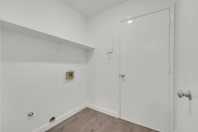 clothes washing area featuring hookup for a washing machine, wood finished floors, baseboards, laundry area, and electric dryer hookup