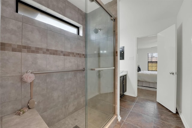 full bathroom featuring baseboards, a healthy amount of sunlight, a stall shower, and ensuite bathroom