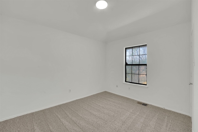 carpeted empty room featuring baseboards and visible vents