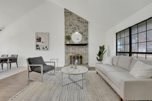 living area with a fireplace, high vaulted ceiling, and baseboards