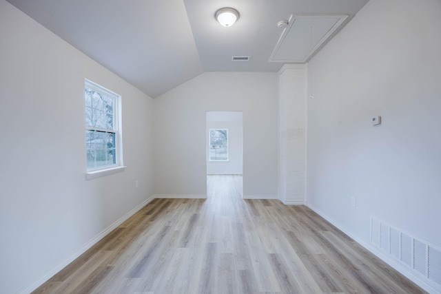 spare room with attic access, visible vents, and a wealth of natural light