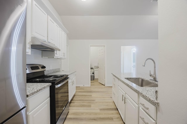 kitchen with under cabinet range hood, a sink, white cabinetry, light wood-style floors, and appliances with stainless steel finishes