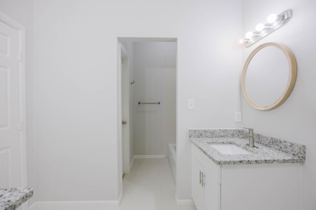 bathroom with vanity, washtub / shower combination, baseboards, and tile patterned flooring